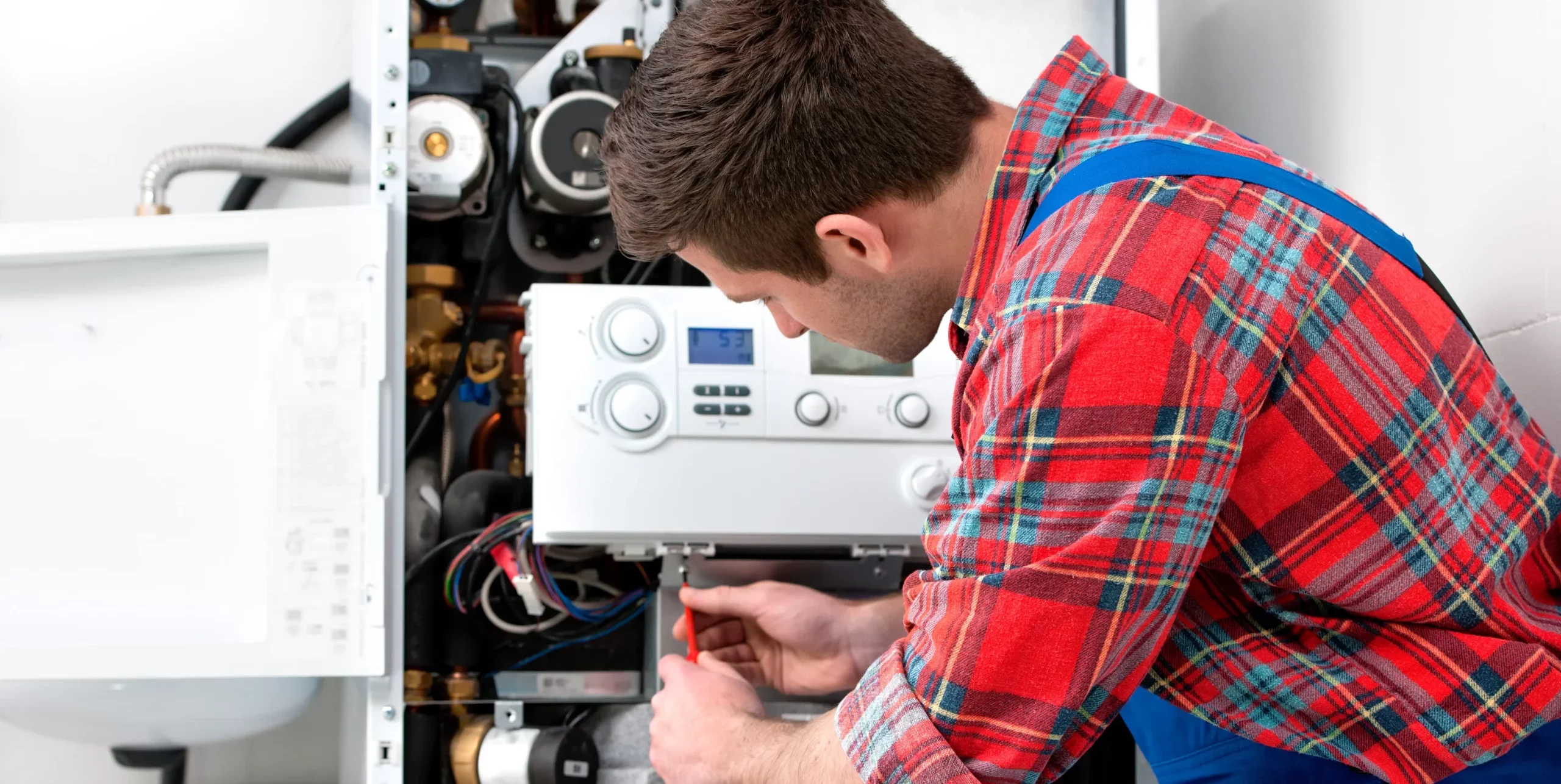 technician is inspecting an HVAC system