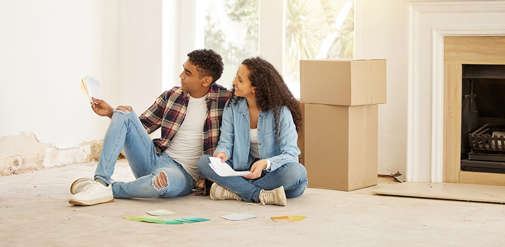 a young couple making a decision together in their new home