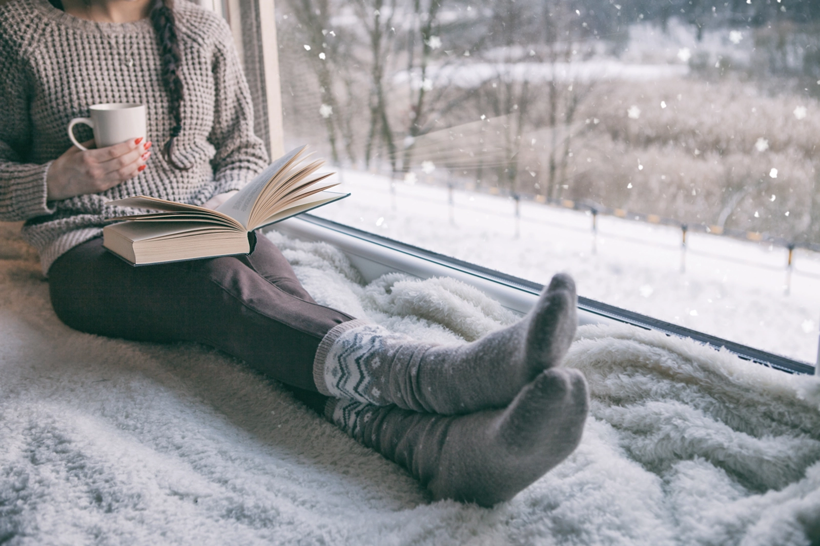 sitting by window during winter