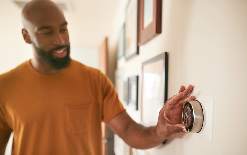 Man heating home with smart thermostat